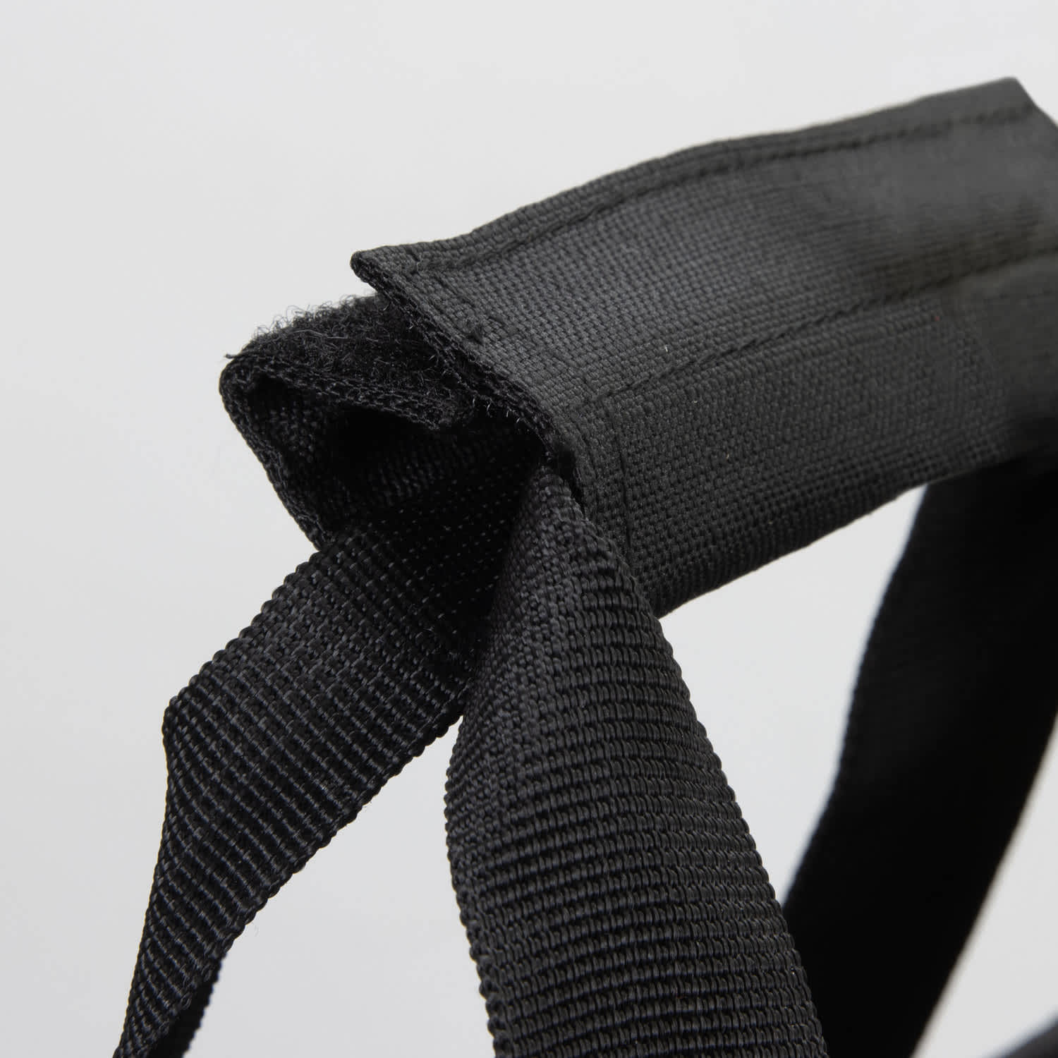 A black strap featuring durable fabric, designed for carrying or securing items.