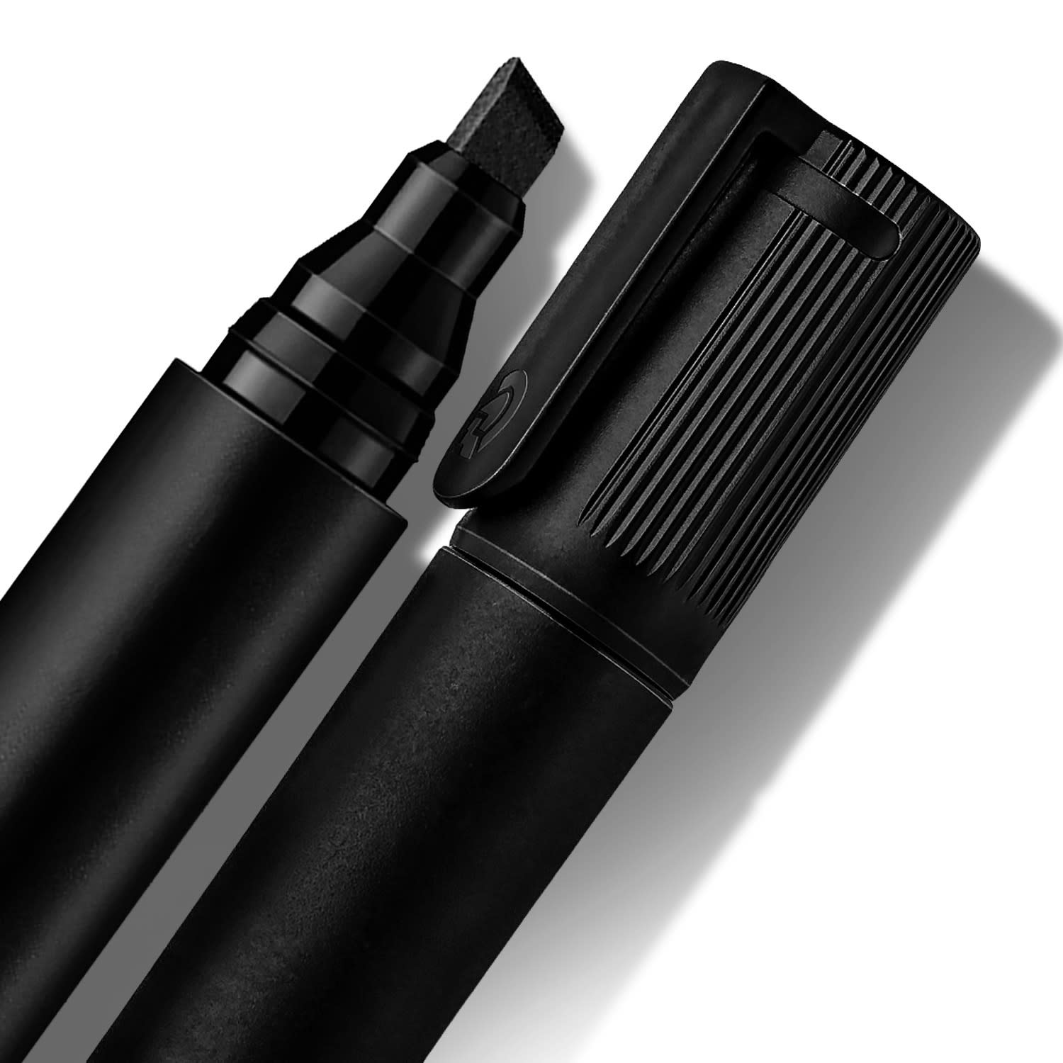 A permanent marker with a chisel tip in black, featuring a textured grip and a clip on the cap.
