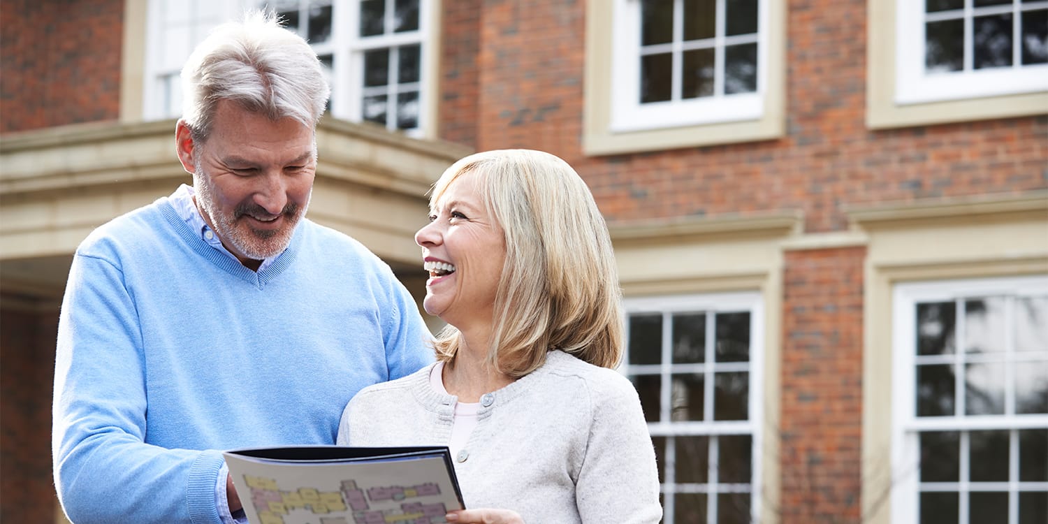 Home sellers looking at listing brochure - cash sale vs. traditional sale concept