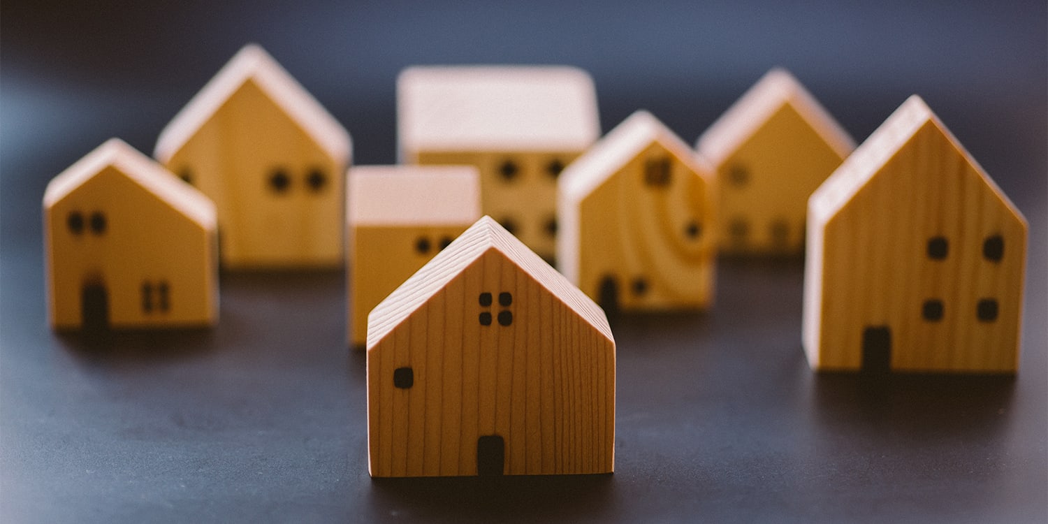 Set of wooden houses to represent landlord rental property ownership