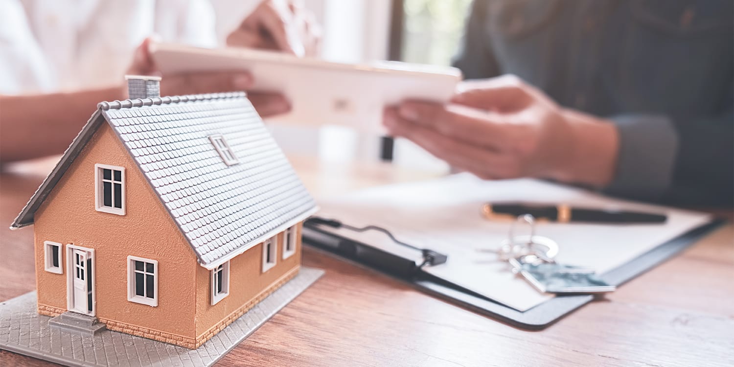 Couple reviewing property tax forms - tax default concept