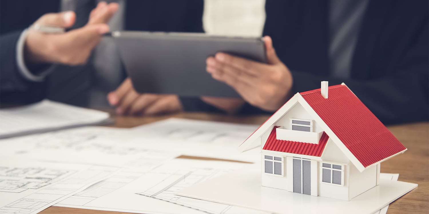 Lender talking to real estate investor about loan options