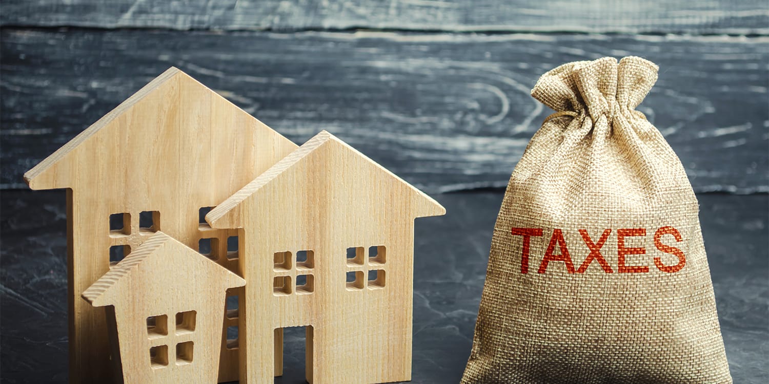 Conceptual image of property taxes dominating house
