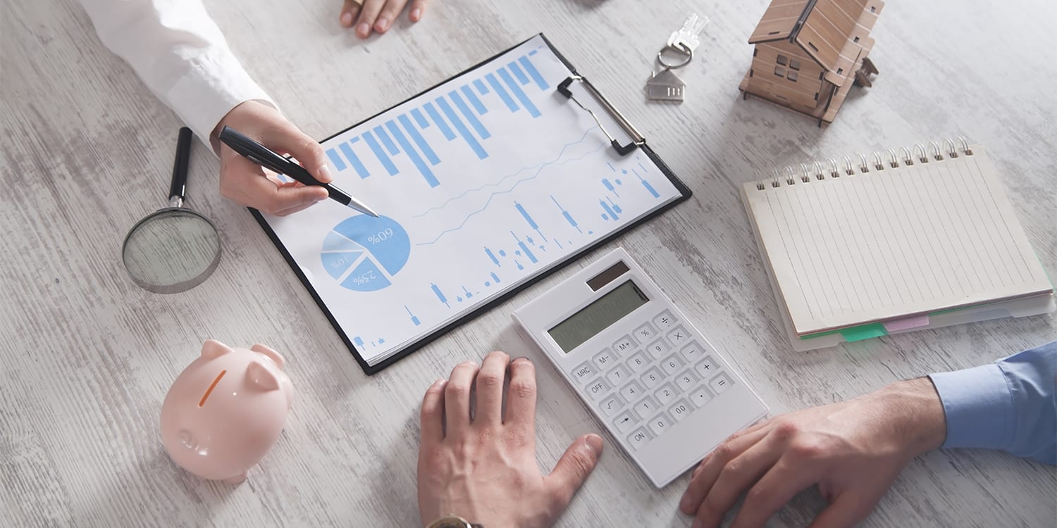 Real estate investors looking over investing data