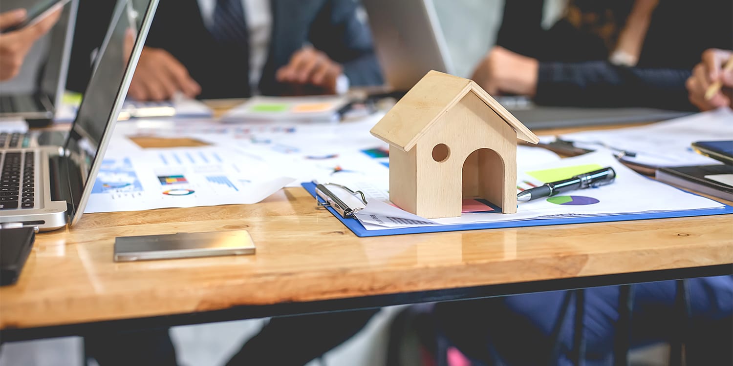 Real estate investors around table forming home buying network