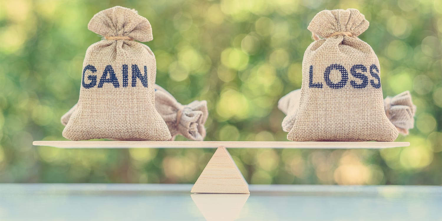gain and loss on a scale, representing investment property strategy