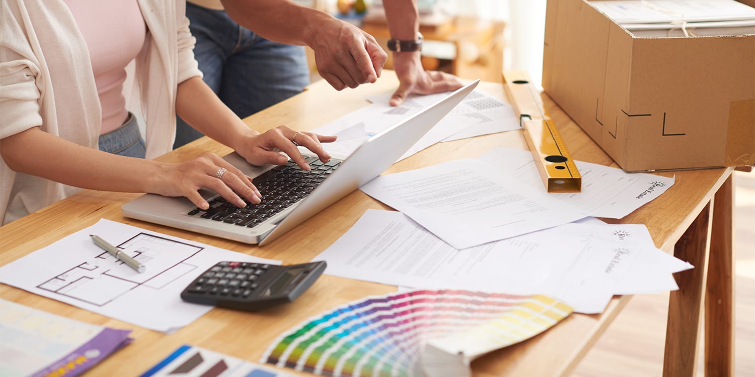 Real estate investors performing property analytics and renovation budget
