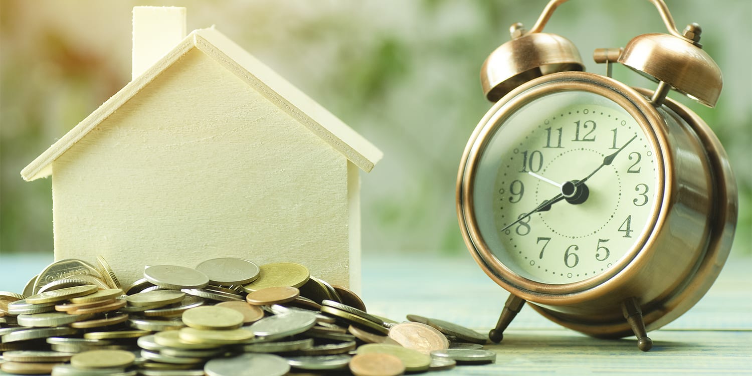 Clock and house to represent right time to sell