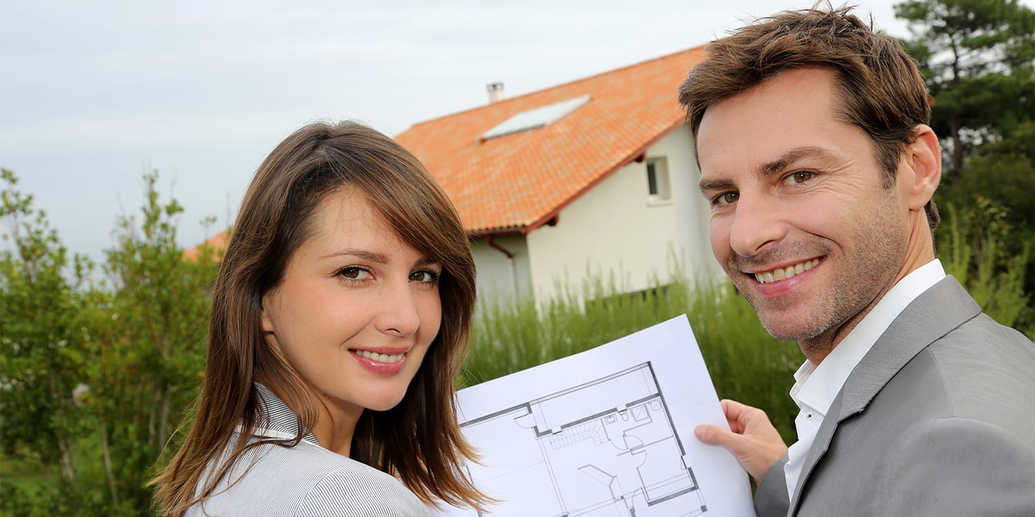 Real estate investor couple looking at house floor plan