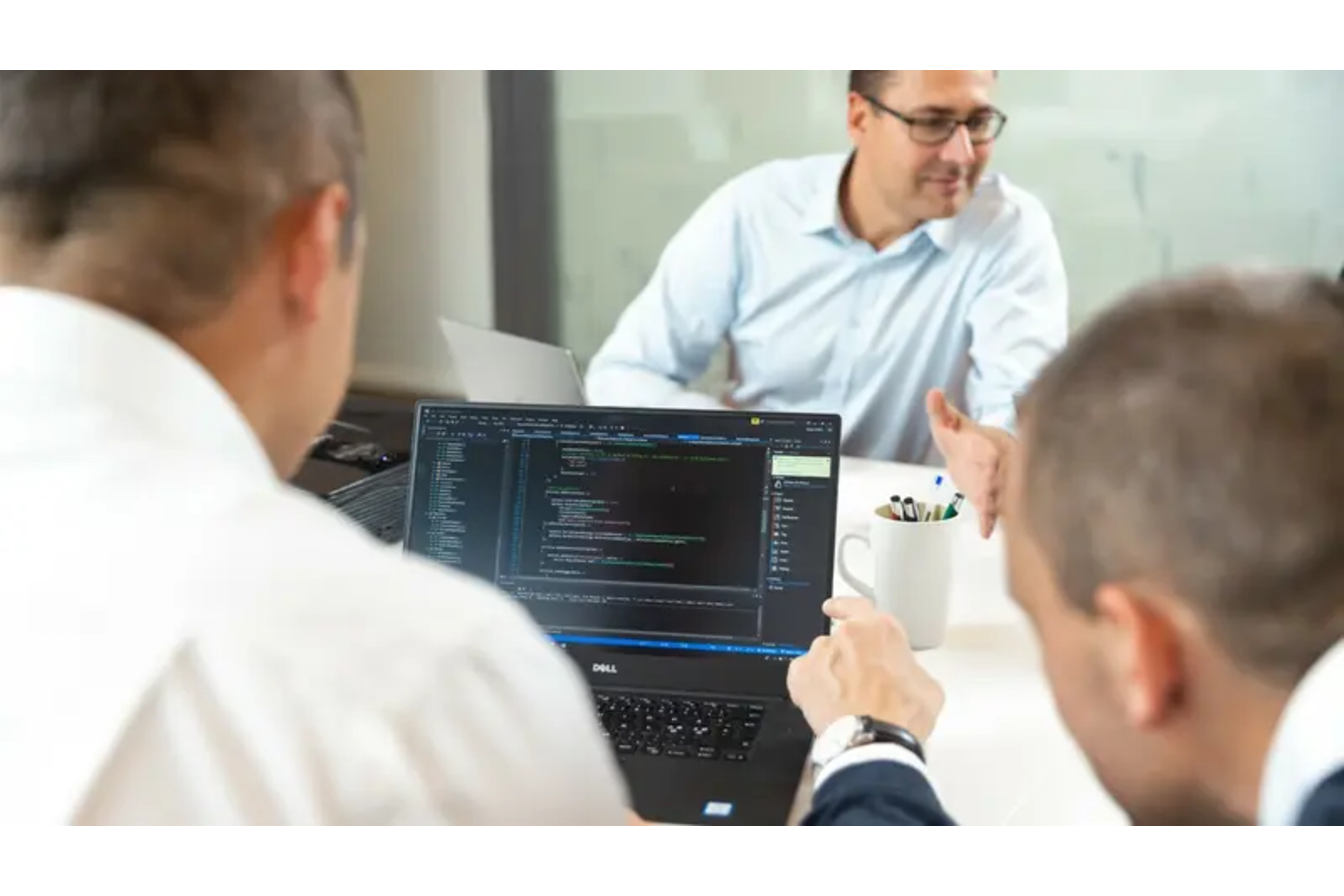 Colleagues discussing sales in a meeting