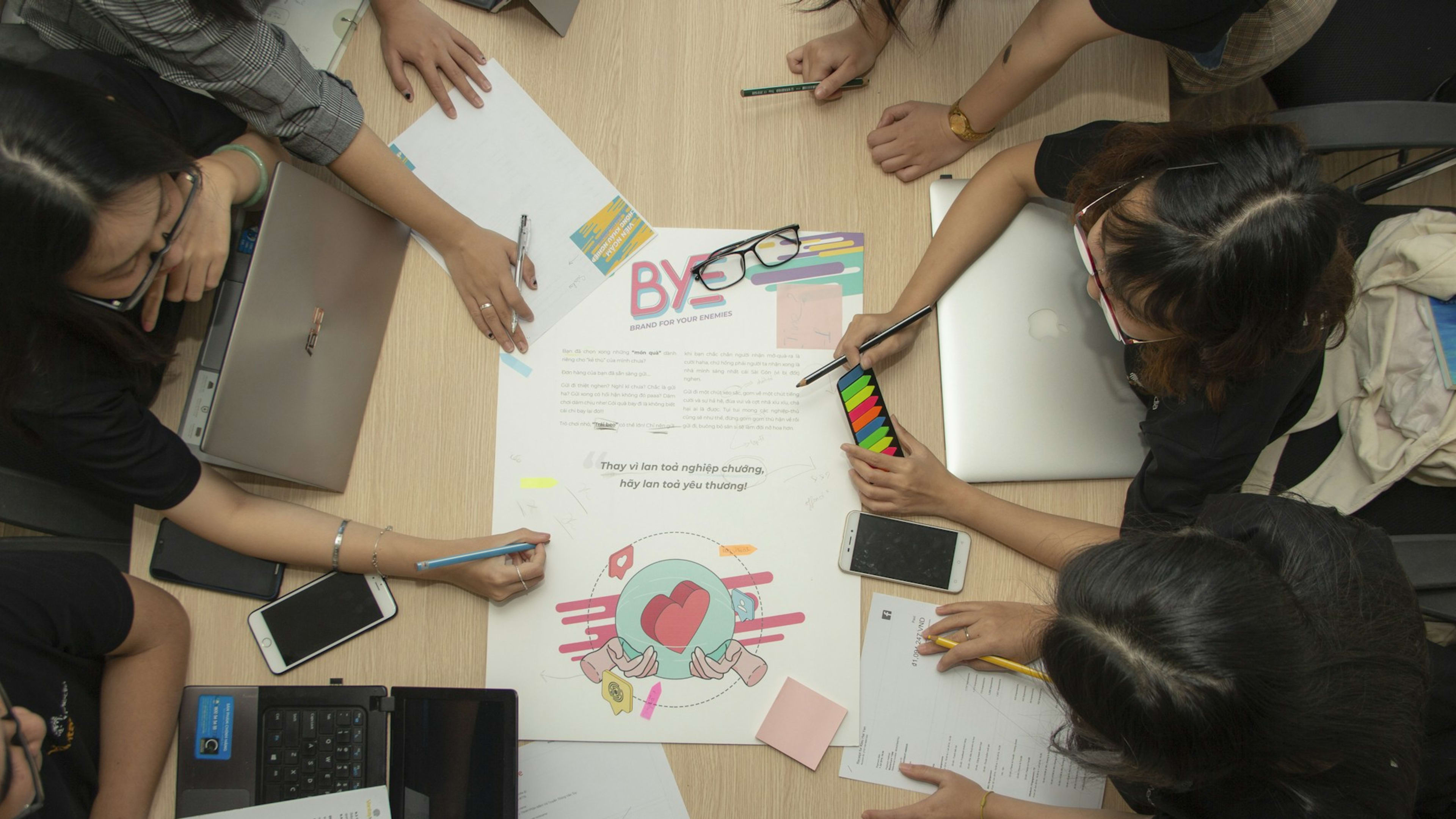A team discusses ideas and tasks around a meeting table.