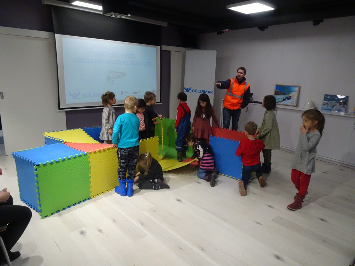 Miniaturka zdjęcia obrazującego osoby podczas wydarzenia pt.Warsztaty dla dzieci "Budowa II linii metra"