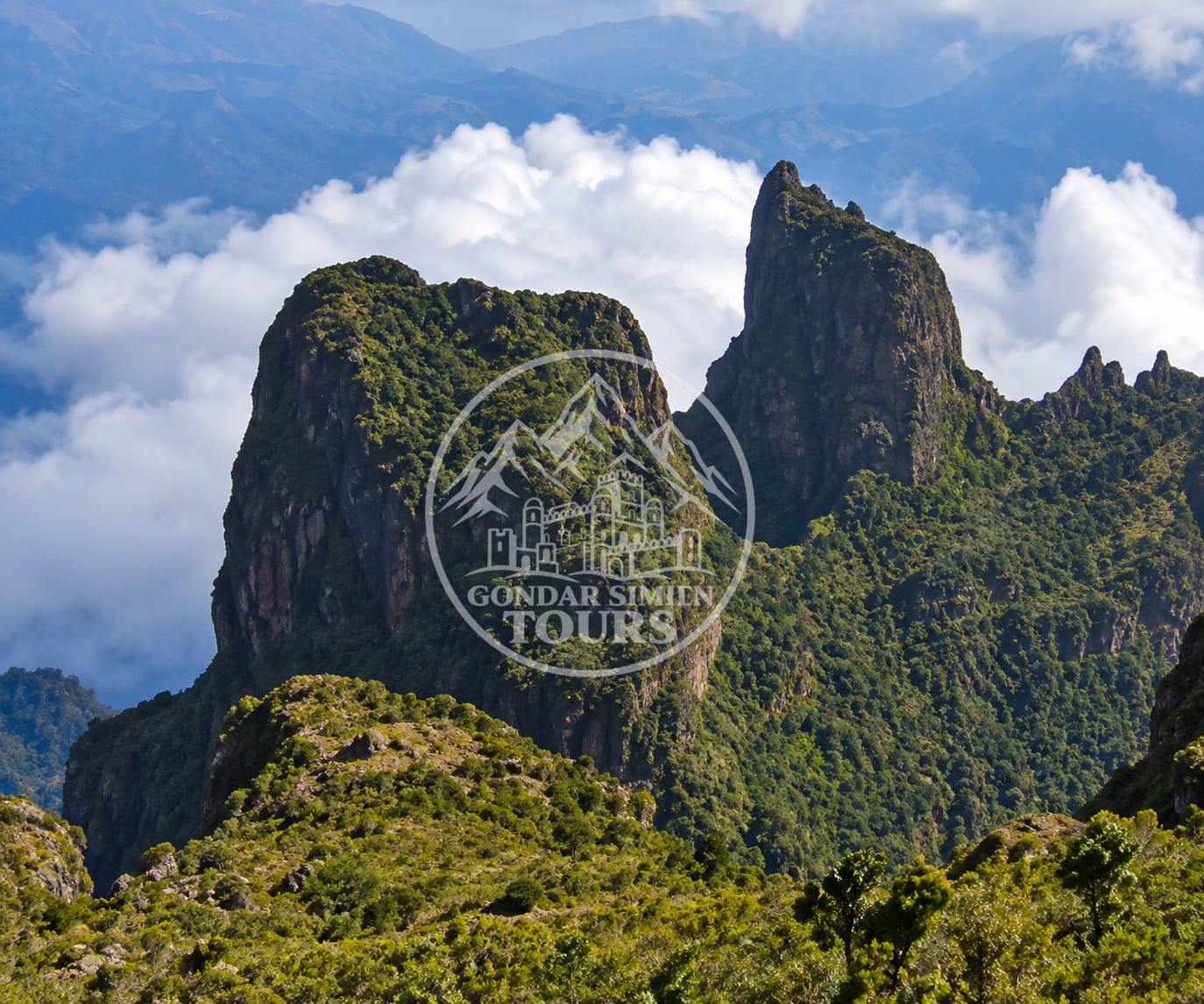 Rocky pinnacles rising above green slopes near Ambaras