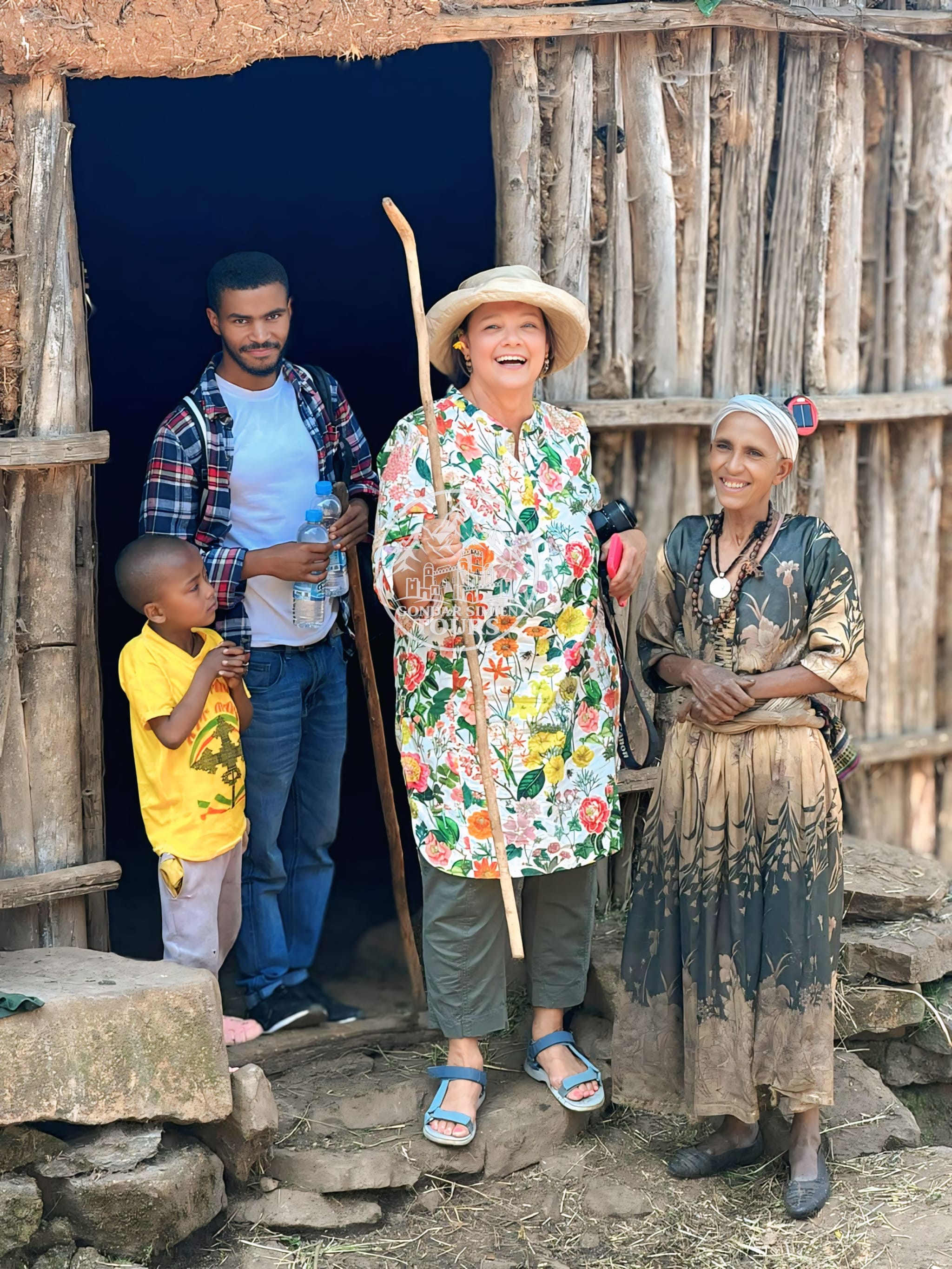 Visitors and local hosts gathered at the doorway of a house