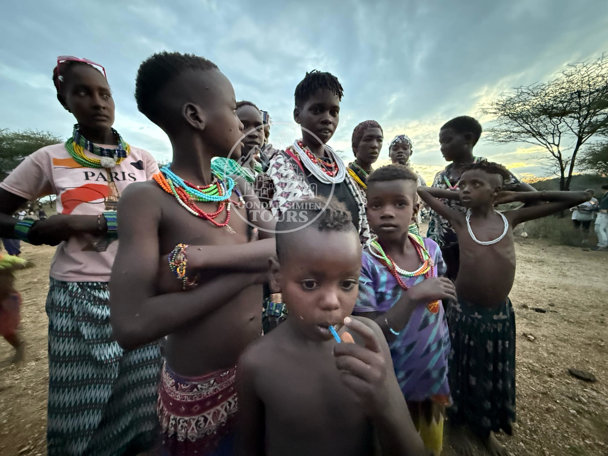 A group of adults and children standing together outdoors