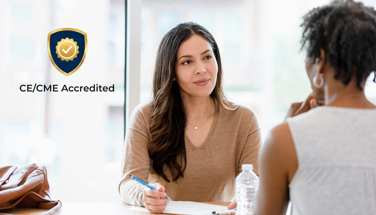 Woman at computer with CE Accreditation badge