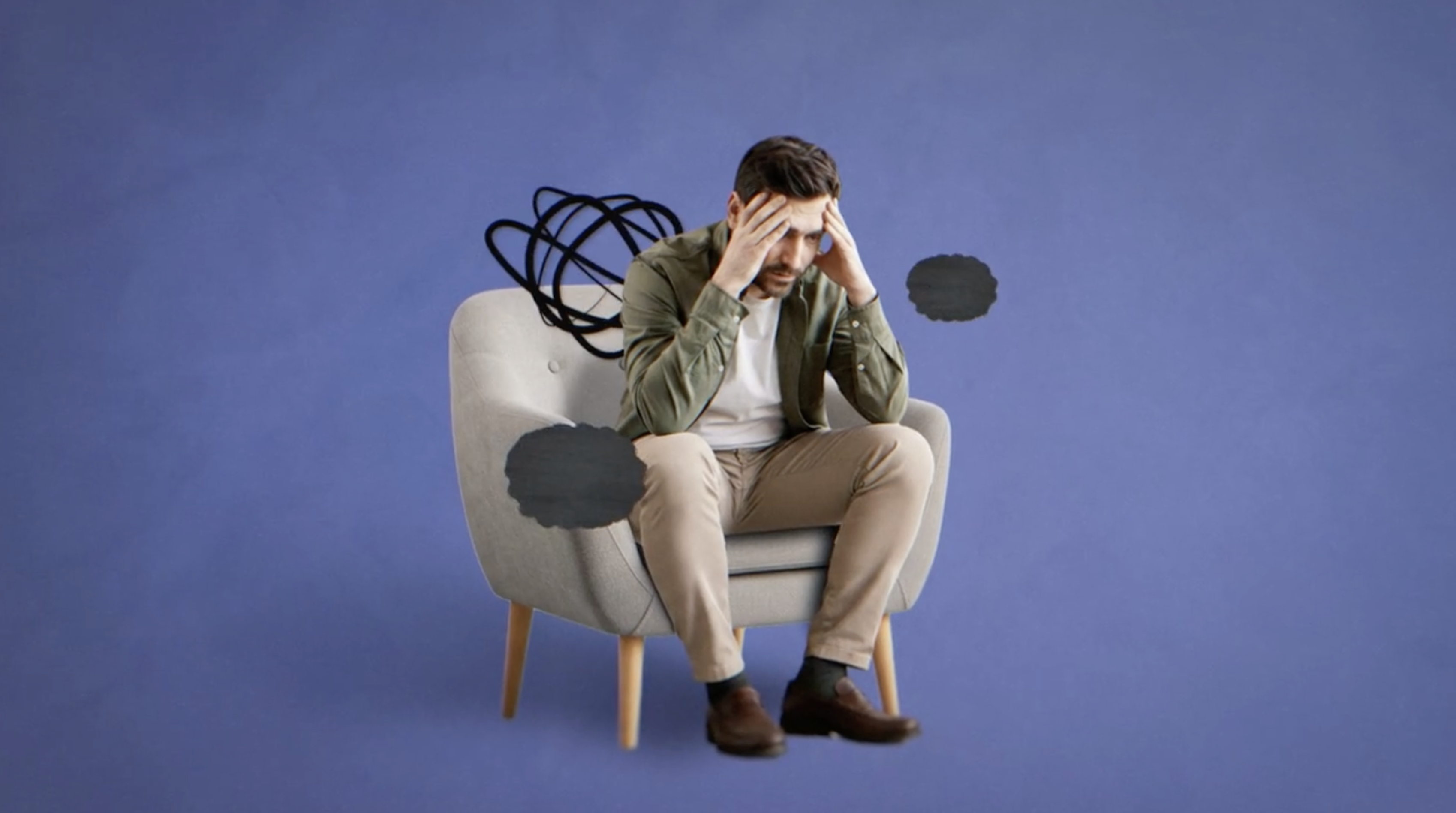 man sitting in chair with clouds and squiggles around his head