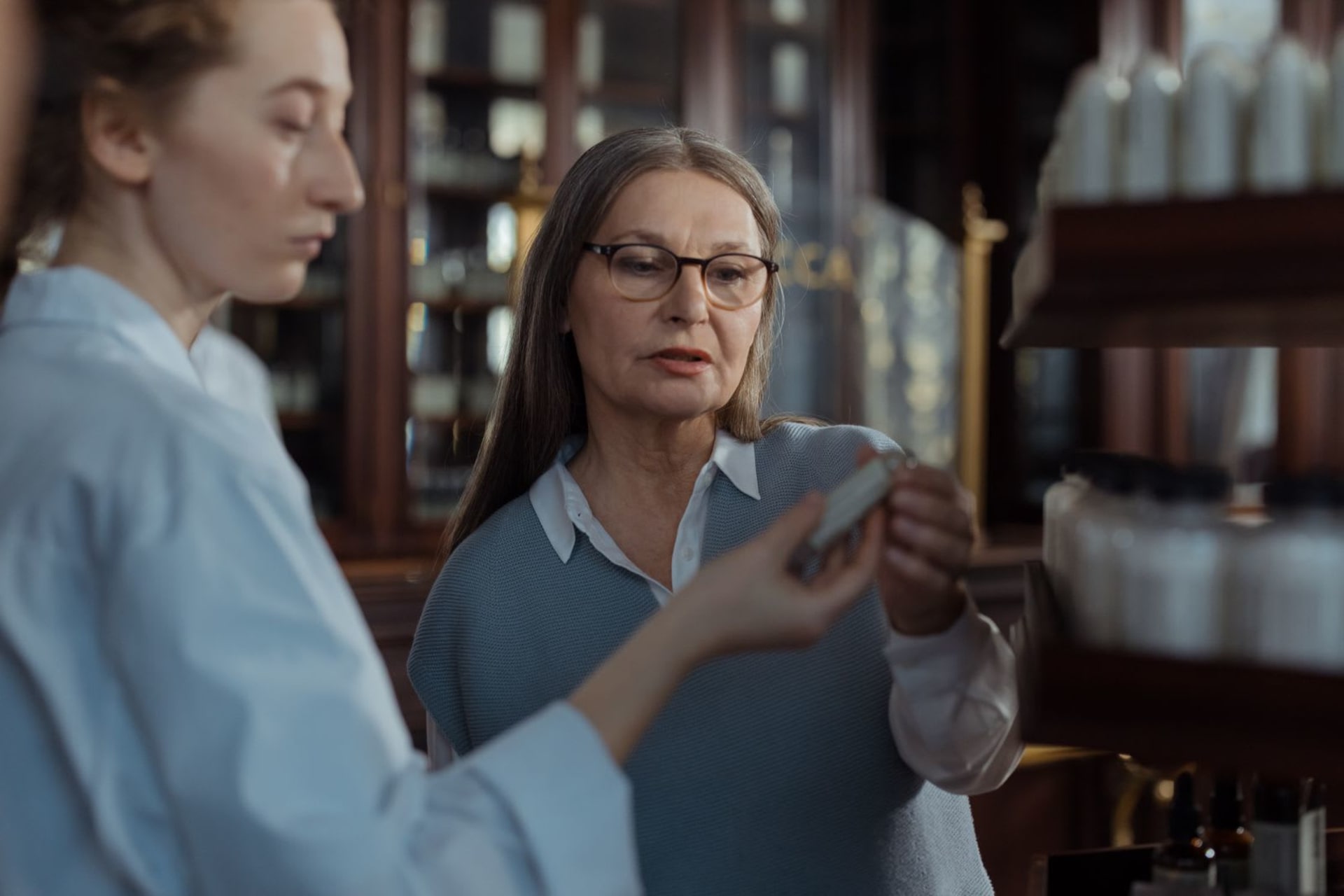 Pharmacist helping a customer choose a product in a pharmacy