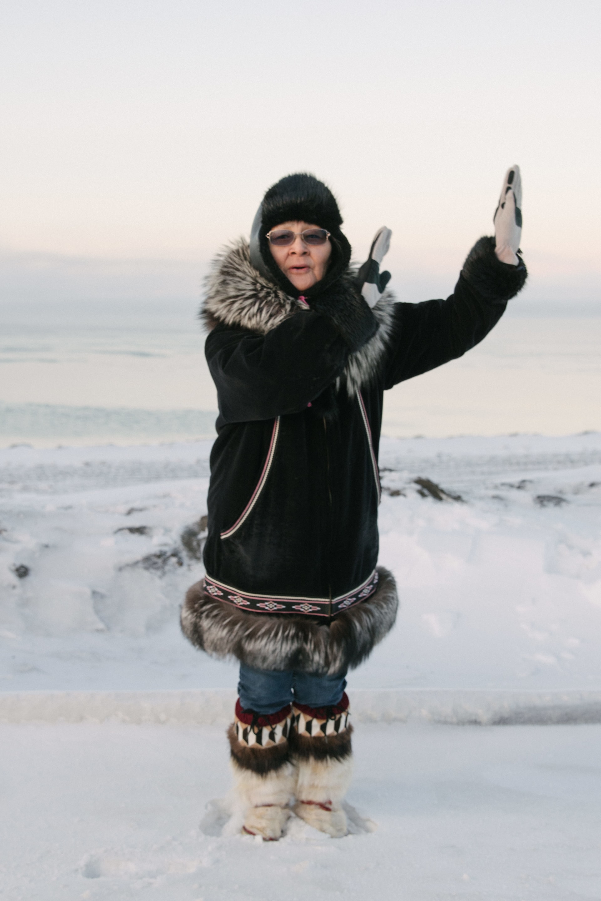 Nora Adams, wife of a whaling captain, demonstrates a traditional Iñupiaq dance outside of the village of Utqiagviq, Alaska.
