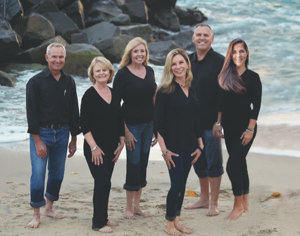The purdy homes team posing on a jetty