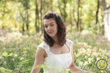 wedding dress with lace cap sleeves and gazing bride in fall grasses