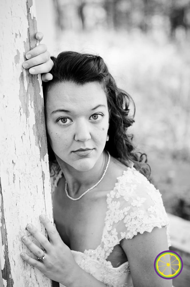 bride wth small necklace and gazing eyes in lace wedding dress in midwest