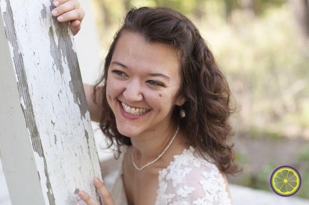 happy smiling bride in Saint Louis suburb against weathered building