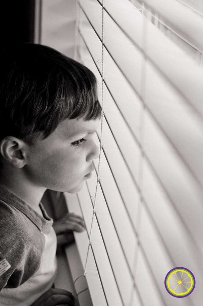 boy looks out window in columbia mo