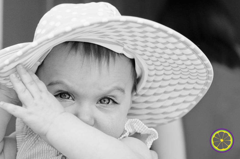 baby pulls on sunhat