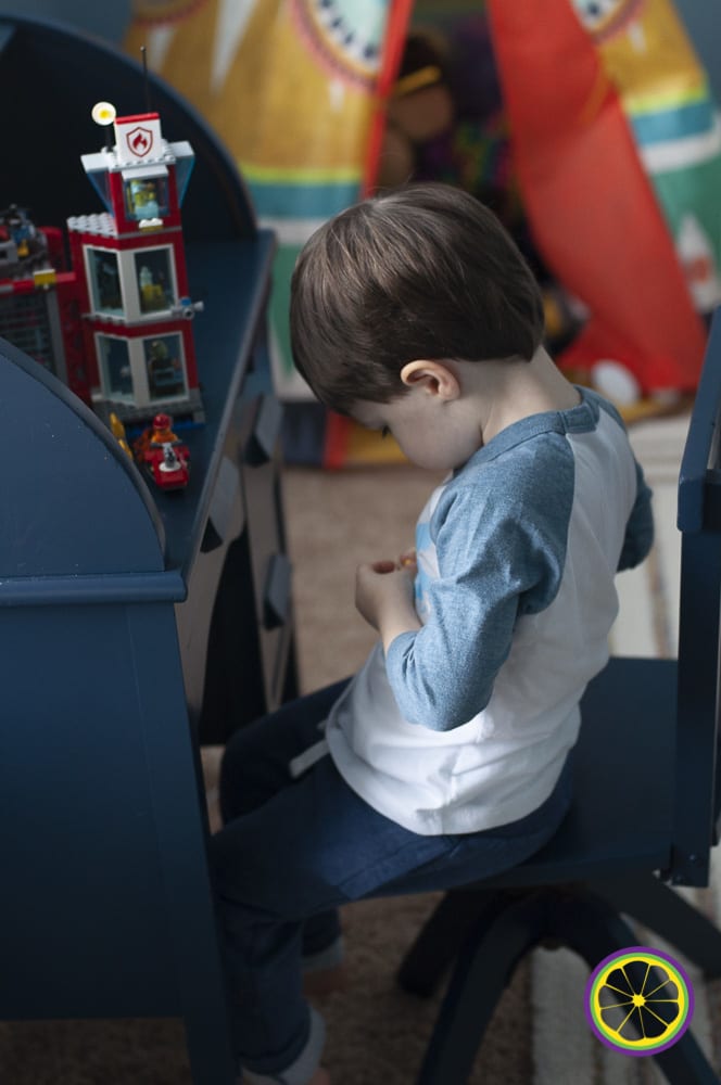 preschool boy at desk playing with lego toys in MO