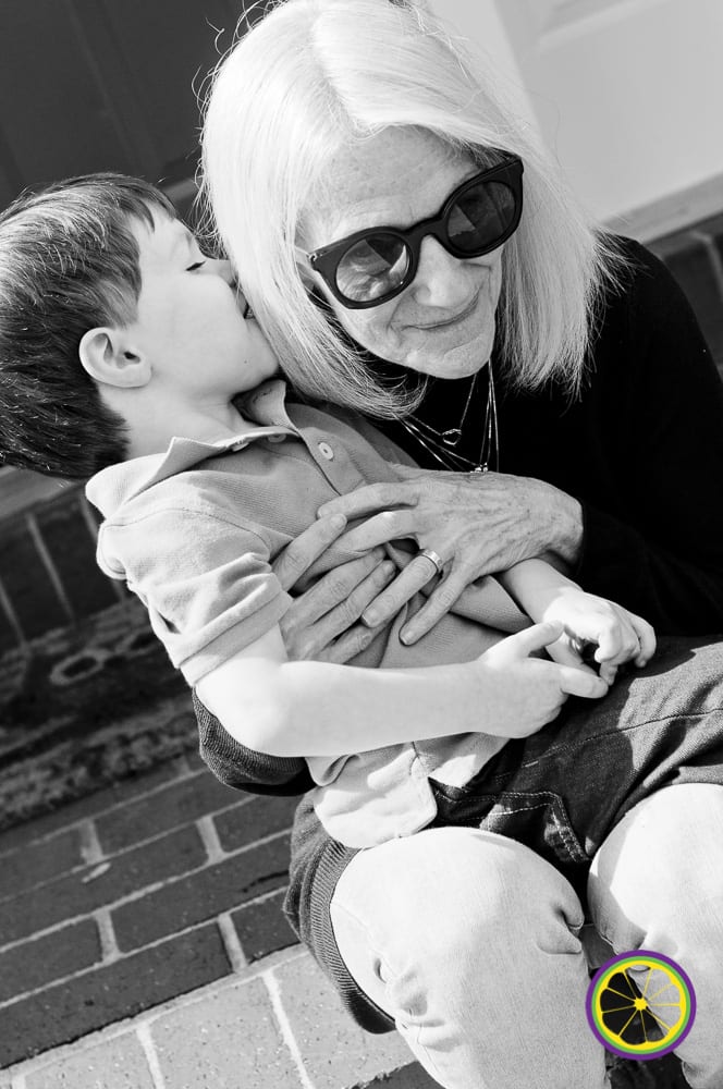preschool boy whispering to grandma