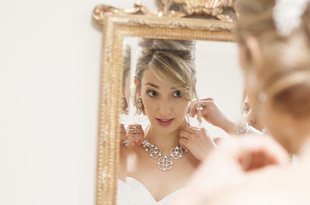 Photo of a bride's eyes looking into a mirror while getting ready