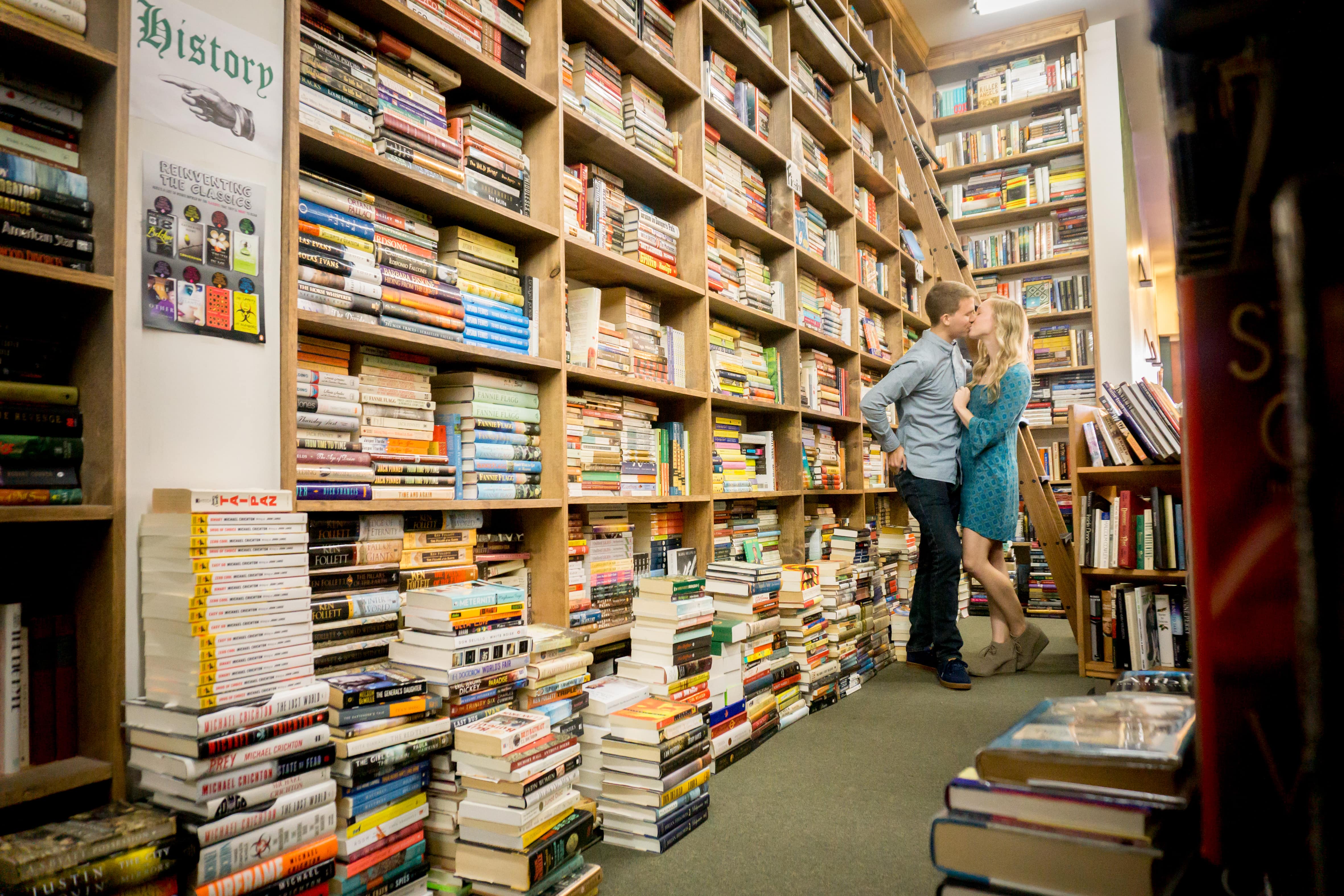 Kissing engagement couple in bookstore in Maplewood MO