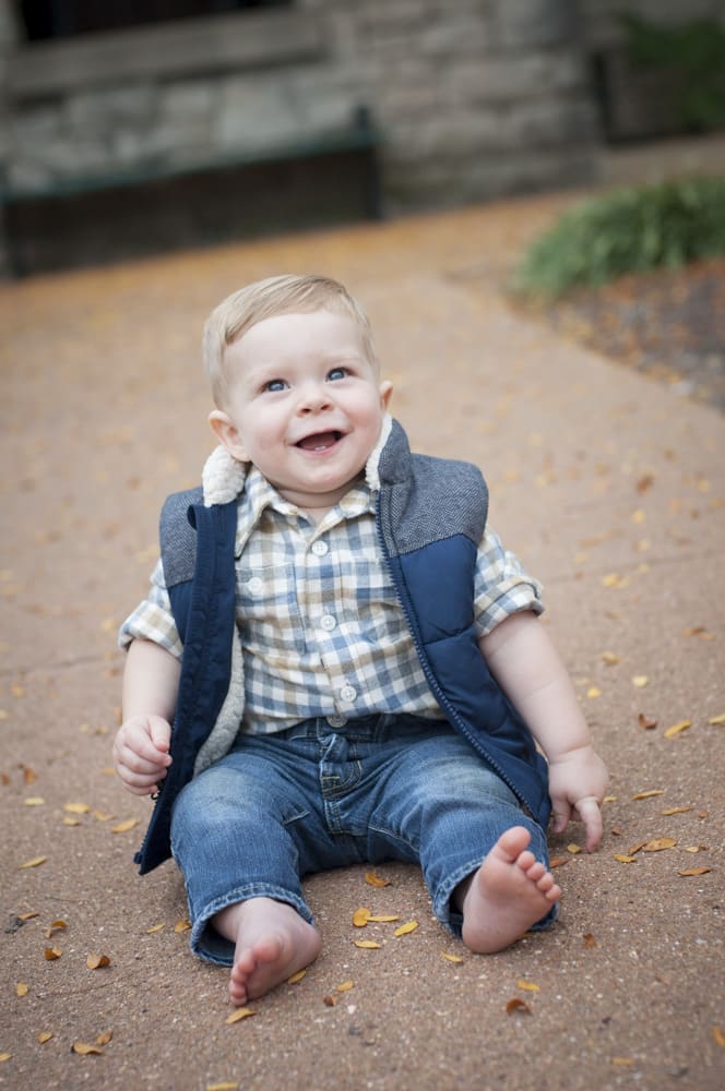 Fall portrait of a one year old boy in a vest in the autumn at Laumeier Sculpture Park