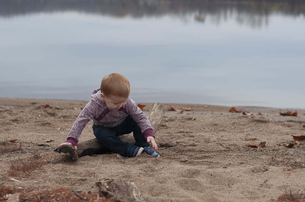 young boy sitting on the beach of Creve Couer Lake in St. Louis Mo