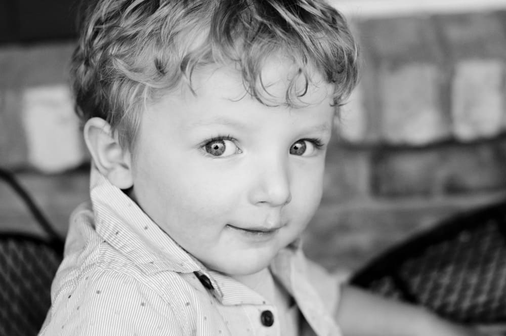 photograph of a little boy on his front porch in West County MO