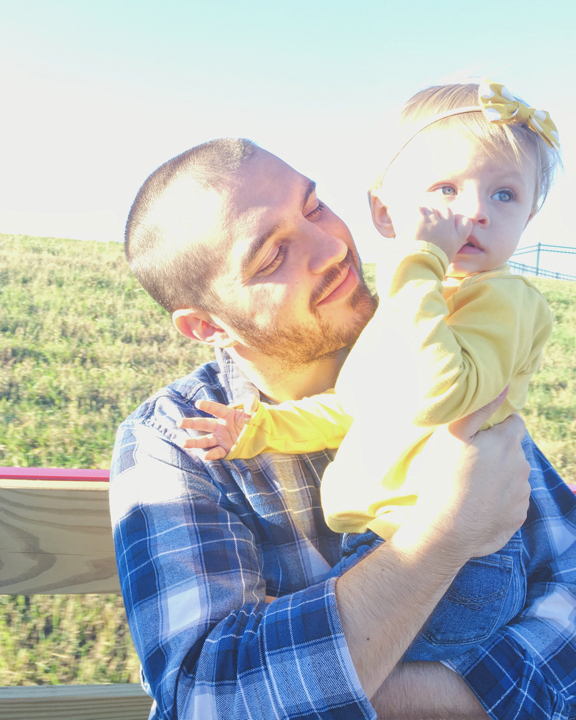 Mike holding Rose on a hay ride