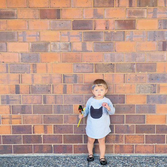 Rose standing in front of a brick wall