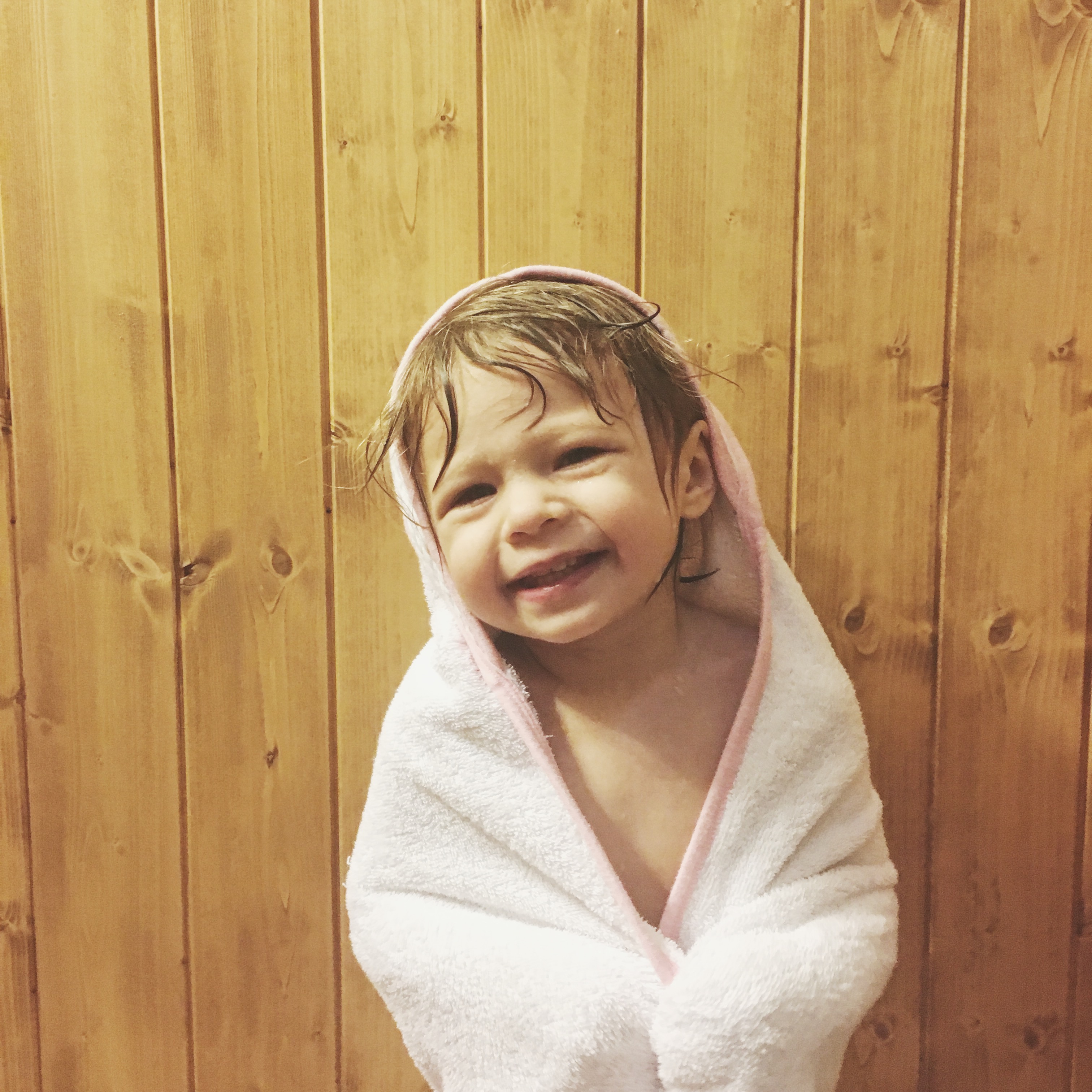 Rose wearing a towel after a shower, smiling