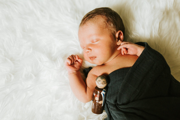 Kolbe sleeping holding a St. Maximilian Kolbe peg doll