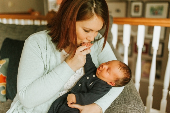 Becky holding Kolbe and kissing his hand
