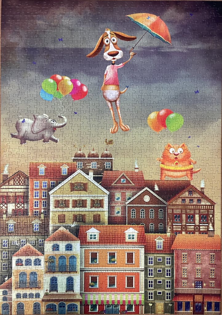 A whimsical illustration of a dog, elephant, and cat floating above a European-style town under a stormy sky.