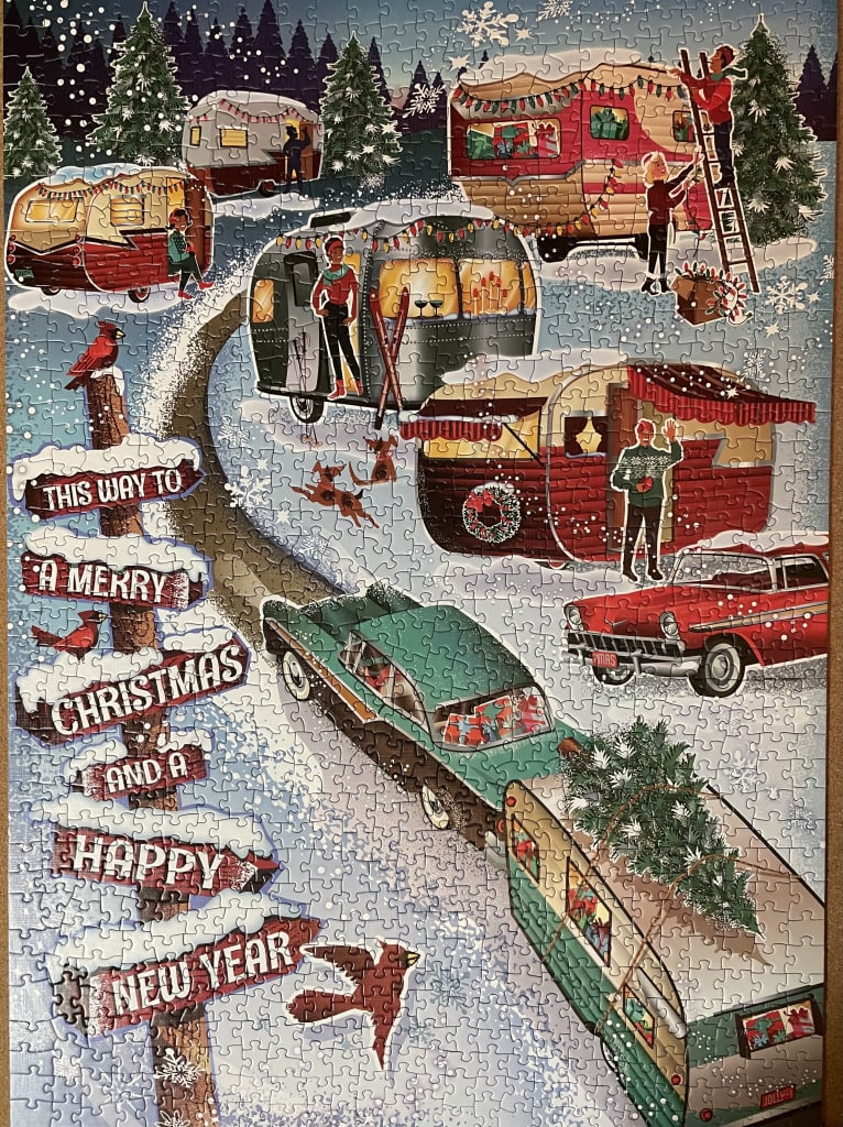 An illustration of a snowy campsite with vintage campers, cars, and a sign wishing a Merry Christmas and Happy New Year.