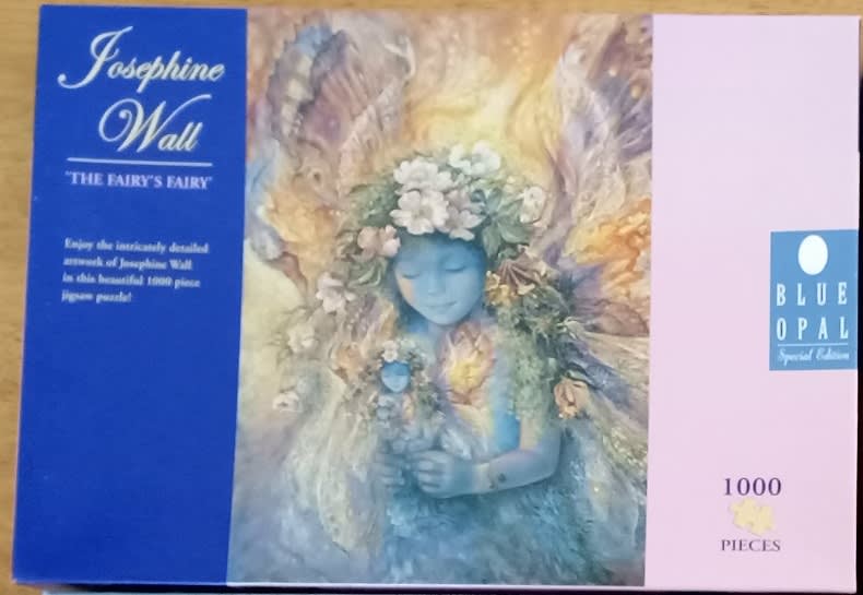 An ethereal painting of a blue-skinned fairy holding a smaller doll-like figure, surrounded by flowers and wings.