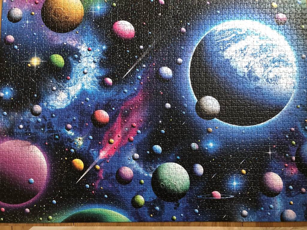 An artistic illustration of a vibrant deep space scene featuring numerous colorful planets and nebula clouds.