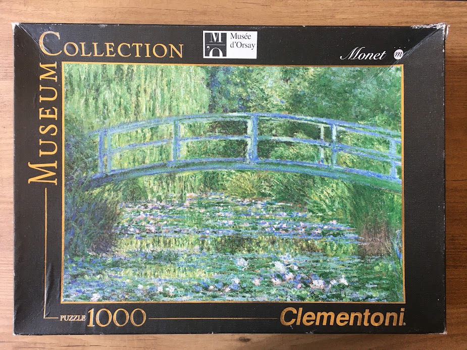 Impressionist painting of a green Japanese-style bridge over a water lily pond by Claude Monet.
