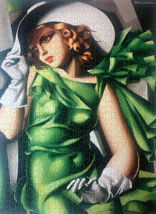 A woman in a green dress and white hat, styled in Tamara de Lempicka
