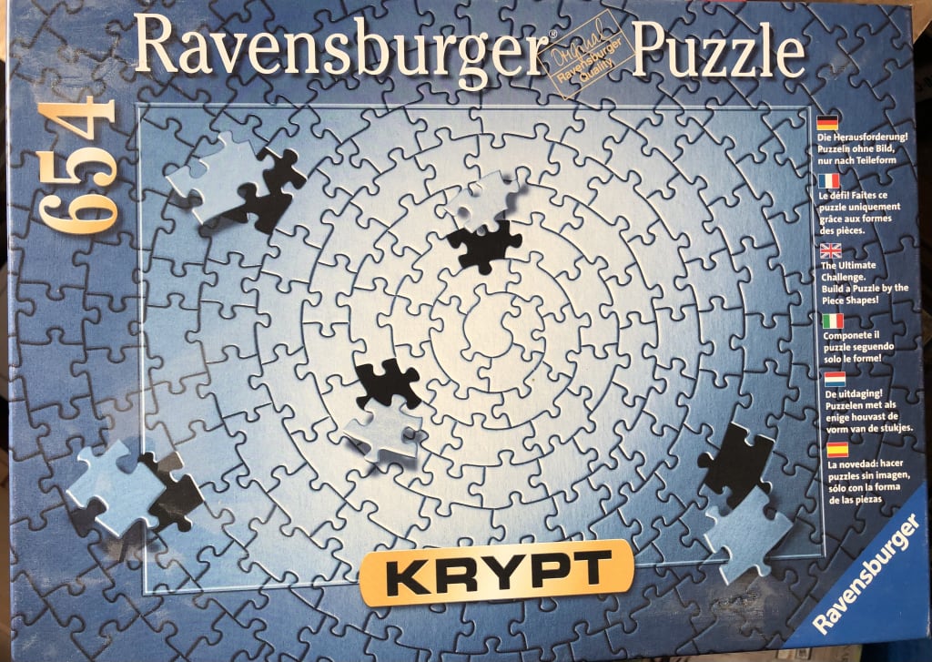 A gradient blue circular spiral pattern of jigsaw pieces.