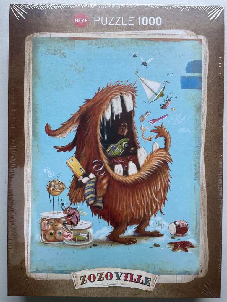 A whimsical illustration of a shaggy, wide-mouthed orange monster surrounded by surreal objects on a blue background.