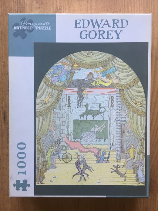 An Edward Gorey illustration featuring a surreal theater stage with dancers, strange creatures, and arching curtains.